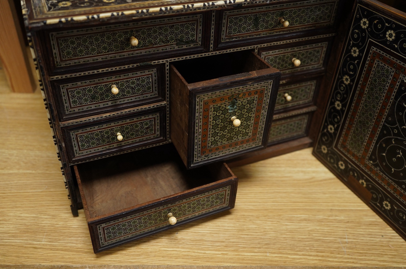 An early 17th century Indo-Portuguese ivory inlaid table cabinet, Gujarat, 29cm high. Condition - poor, losses CITES Submission reference 3XBFQXPT